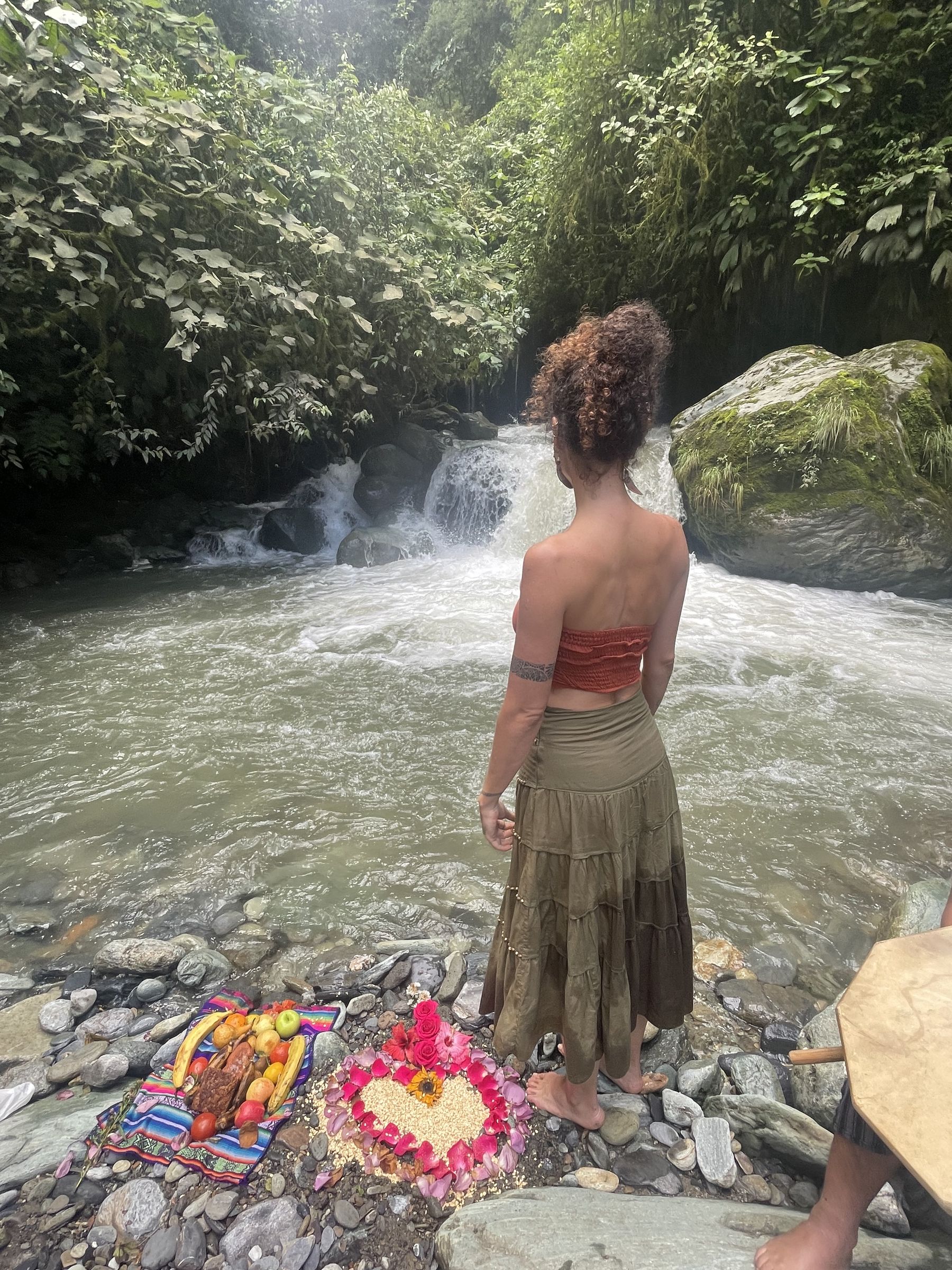 An offering of fruit and flowers laid by the river during a water ceremony in the Ecuadorian Amazon